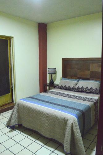 a bedroom with a large bed in a room at Hotel Topacio in San Juan de los Lagos