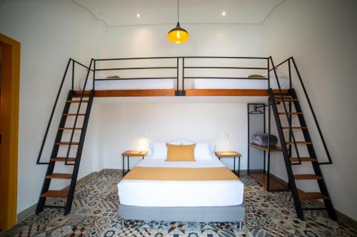a bedroom with a bunk bed and two bunk beds at Casa Serafin Hotel in Salento