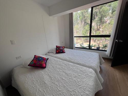 Ένα ή περισσότερα κρεβάτια σε δωμάτιο στο Cozy and new depto in Cusco