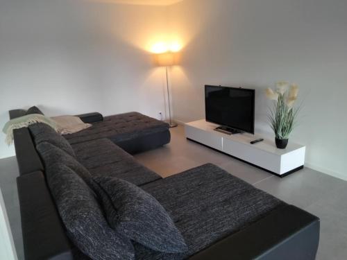a living room with a couch and a flat screen tv at strand huset in Halmstad