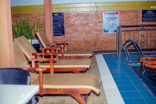 a row of chairs and tables in a restaurant at Forever Hotel and Suites in Owerri