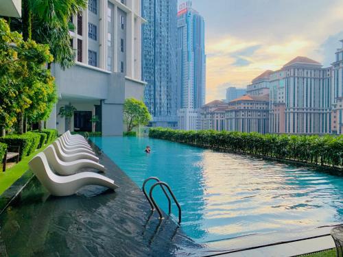 a swimming pool in a city with tall buildings at KLCC The Mews Luxury suites Malaysia in Kuala Lumpur