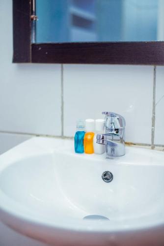 a bathroom sink with two toothbrushes and a mirror at Forever Hotel and Suites in Owerri