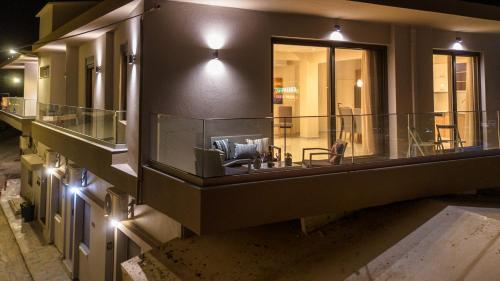a building with a balcony with a couch on it at Galini Studio, next to the beach in Rethymno Town