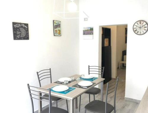 a dining room with a table and chairs at Appartamento Sbirciamare by Zoom In Earth in Marina di Cecina