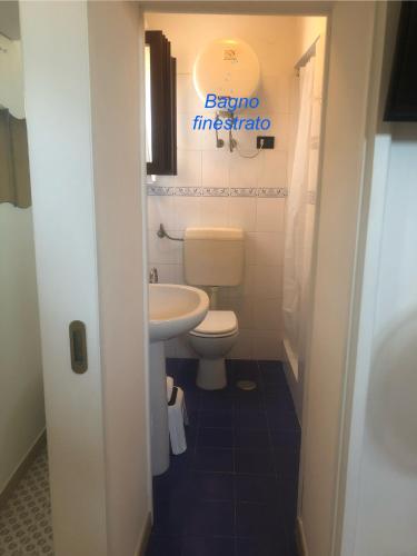 a bathroom with a toilet and a sink at Chez Pépé in Vico Equense