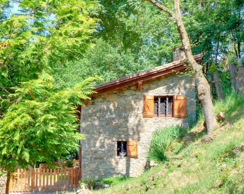 a stone house on a hill with trees at La caseta de Mas Salelles 