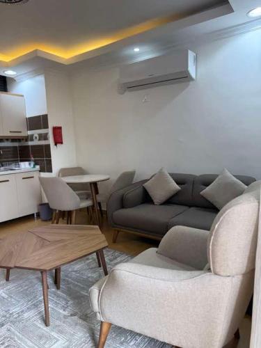 a living room with a couch and a table at Cascadia Hotel Apartments by GF Greenland in Kigali