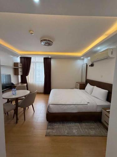 a hotel room with a bed and a table at Cascadia Hotel Apartments by GF Greenland in Kigali