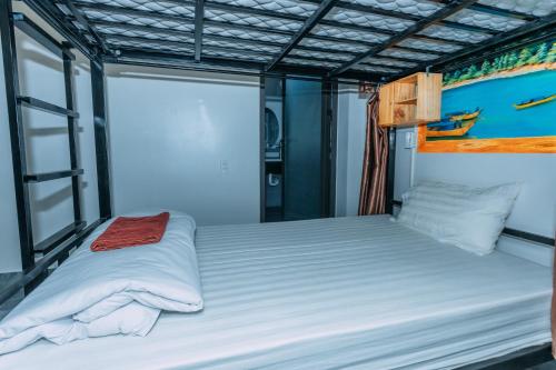 a large bed in a small room with at Green Riverside Cosy Home in Bố Trạch