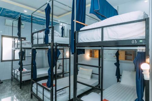 a group of bunk beds in a room at Green Riverside Cosy Home in Bố Trạch