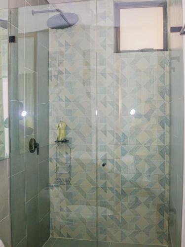 a bathroom with a shower with a glass door at Salinas del Mar Suite in Santa Marta