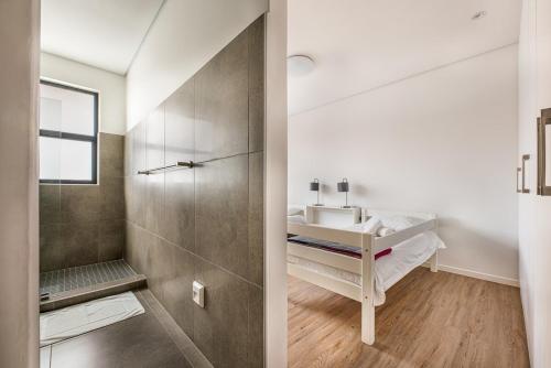 a bathroom with a sink and a shower at 48 On Possession Island in Swakopmund
