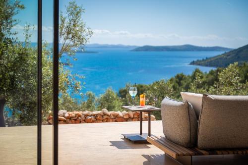 a patio with a table with a view of the water at Villa Nai 3.3 in Žman