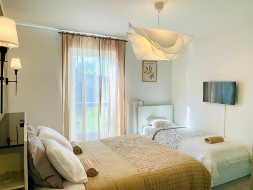 a bedroom with two beds and a window at Shanti - Sérénité in Esch-sur-Alzette