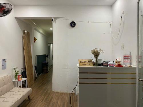a living room with a couch and a counter in a room at Papaya hotel in Ho Chi Minh City
