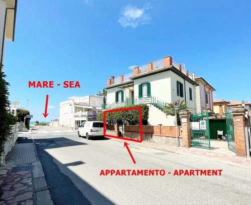 a white car parked in front of a house on a street at Appartamento Mirellino a Marina di Cecina by Zoom In Earth in Marina di Cecina