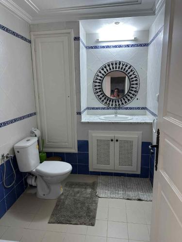 a bathroom with a toilet and a mirror at 2-bedroom apartment in Yasmine Hammamet in Yasmine