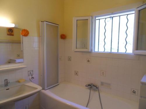 une salle de bain avec une baignoire, un lavabo et une douche dans l'établissement La Sauvagine, à Barjols
