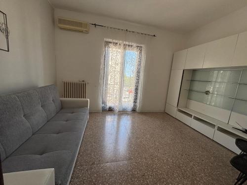 a living room with a couch and a flat screen tv at Casa Doriana in Loreto