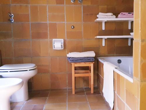 a bathroom with a toilet and a sink and a tub at via dei gerani in Solanas