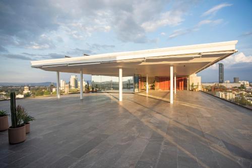 a building with awning on top of a roof at voco Guadalajara Neruda by IHG in Guadalajara