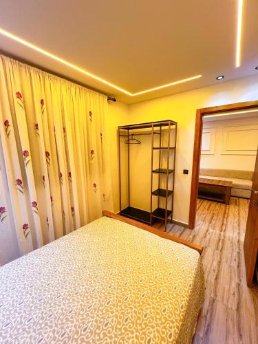 a bedroom with a bed and a yellow wall at Visit Chamal - Zaphir in Oued Laou