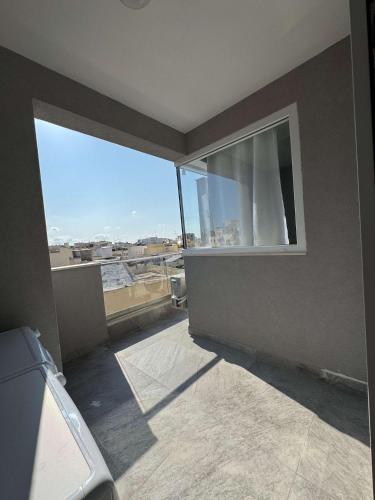 a room with a window with a view of the city at Spacious Stay new 2 Bed and Balcony in Taʼ Penza