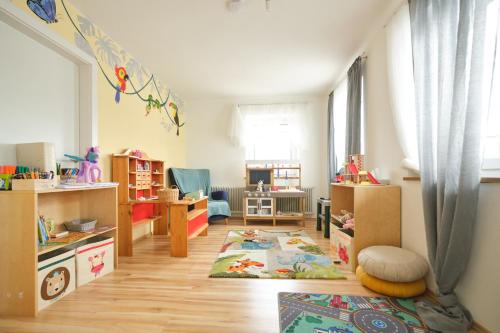 a small room with a childs playroom with boxes and a room with at Santner, Hotel in Eugendorf
