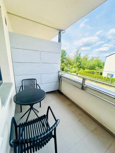 a balcony with two chairs and a table at Villa many separate rooms with Free Parking Praha 4 libuš in Prague
