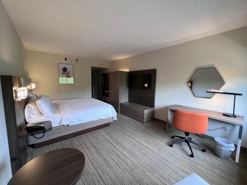 a hotel room with a bed and a desk at Holiday Inn Express Stony Brook-Long Island by IHG in Centereach