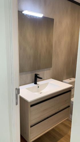 a bathroom with a sink and a mirror at Marina View II Empuriabrava - view port in Empuriabrava