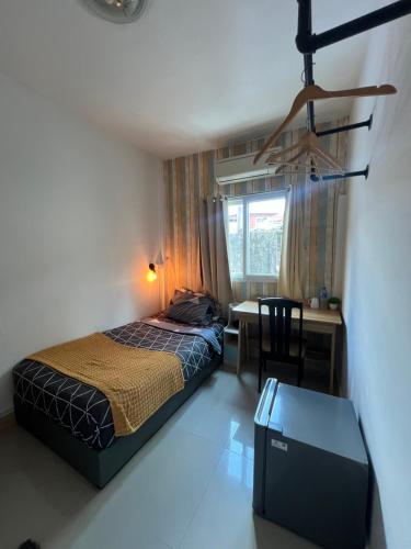 a bedroom with a bed and a desk and a table at La Locanda in Bangkok