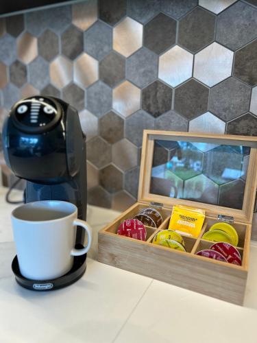 a coffee maker and a cup on a counter next to a coffee at Apartment Suite in Os in Osøyro