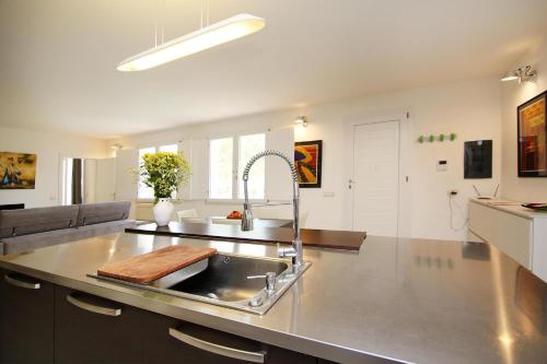 a kitchen with a sink and a counter top at Villa Sa Marchesa in Solanas