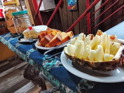 a table with two plates of pies and other desserts at Pousada Dona Elena in Penha