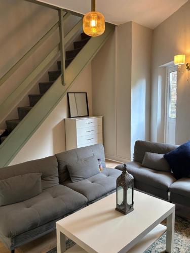 a living room with a couch and a table at Spacious 4BR Home In Greenwich in Plumstead