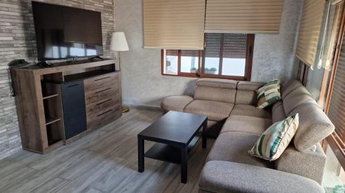 a living room with a couch and a tv at Hôtel Mandy in Tetouan