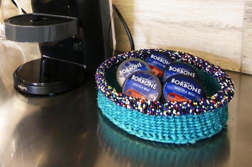 a blue basket of toothpaste on a table next to a blender at Villa Sa Marchesa in Solanas