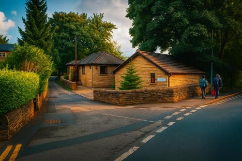 two people walking down a street next to two buildings at Lister Park Bradford 2bed Detached Cottage House Parking Cinema Screen Games Room in Bradford