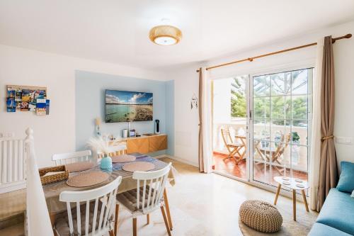 a living room with a table and chairs and a dining room at Casita Azul Las Arenas in Caleta De Fuste