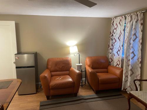 a waiting room with two chairs and a refrigerator at Convenient & Cozy Stay Near Boston in Andover