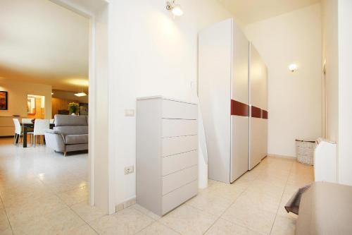 a room with a white closet and a living room at Villa Sa Marchesa in Solanas