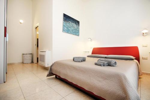 a bedroom with a bed with two towels on it at Villa Sa Marchesa in Solanas