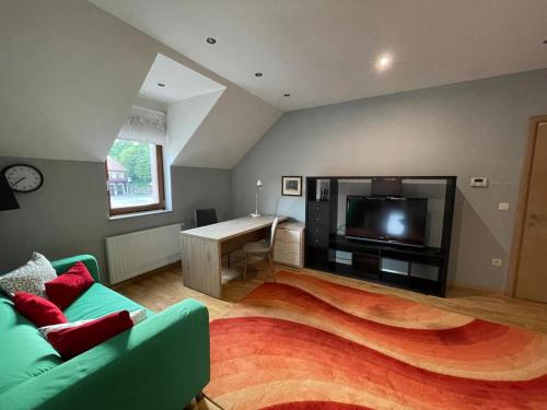 a living room with a couch and a flat screen tv at Smart Stay Apartment Samobor in Samobor
