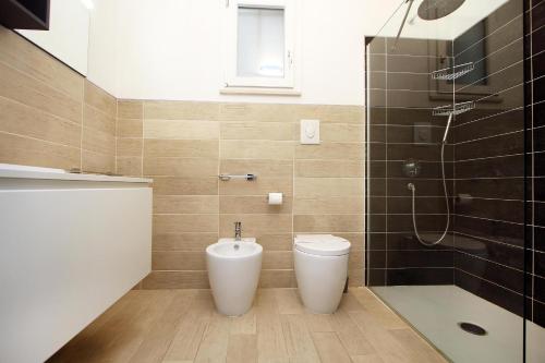 a bathroom with a toilet and a shower at Villa Sa Marchesa in Solanas