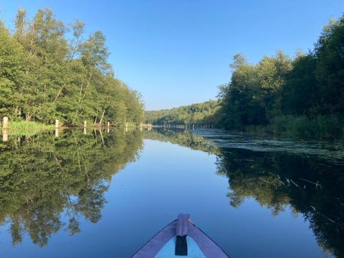 a person paddling a canoe down a river at Sonnenlandhof in Neuruppin