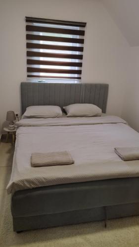 a bed with two pillows on it in a bedroom at Home Delic Komarnica in Šavnik