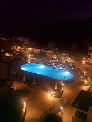 a large swimming pool at night with lights at Charming apartment near beach in Sveti Stefan