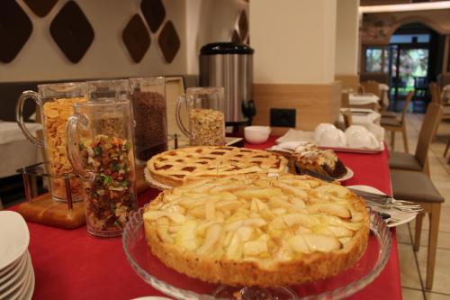 a table topped with pies on a red table at Al Brenta in Levico Terme